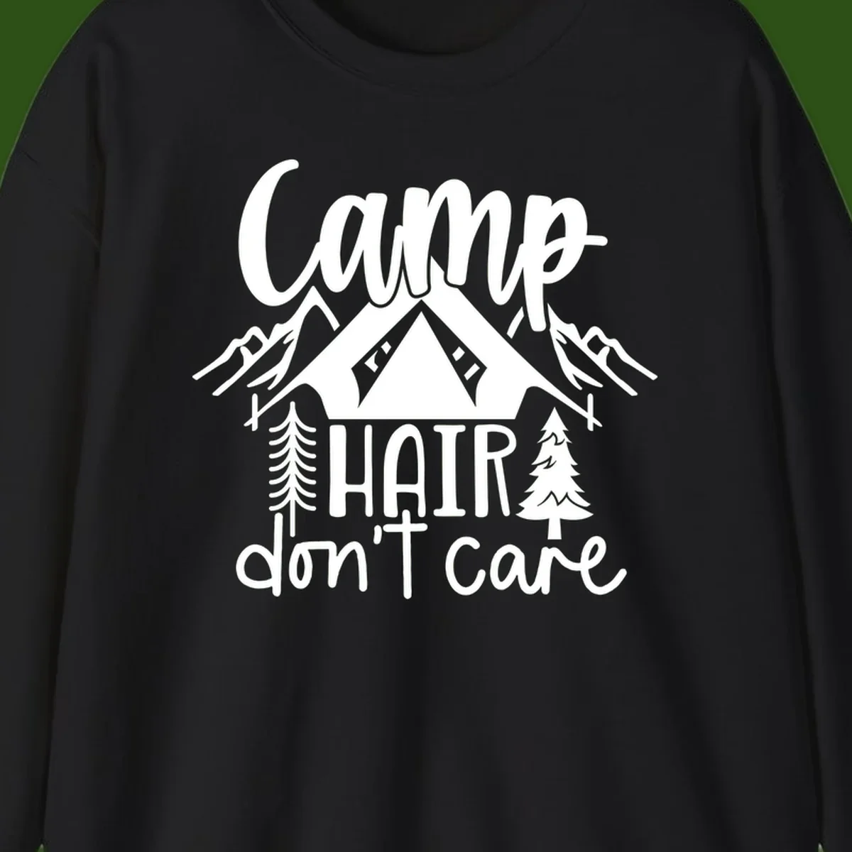 Camp hair don't care design with tent, mountains, pine trees, and campfire illustration with cursive text