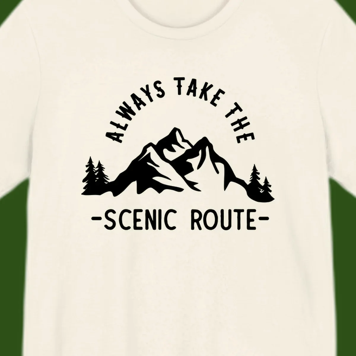 Mountain landscape with evergreen trees and text reading 'Always Take The Scenic Route' in bold lettering