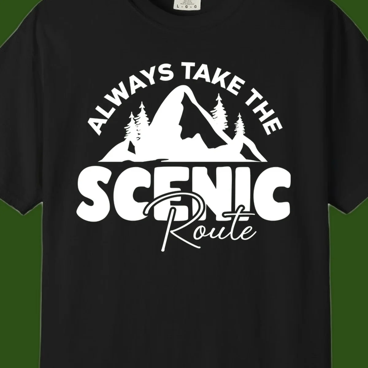 White mountain landscape illustration with evergreen trees and text reading 'All Ways Take The Scenic Route' on gray background