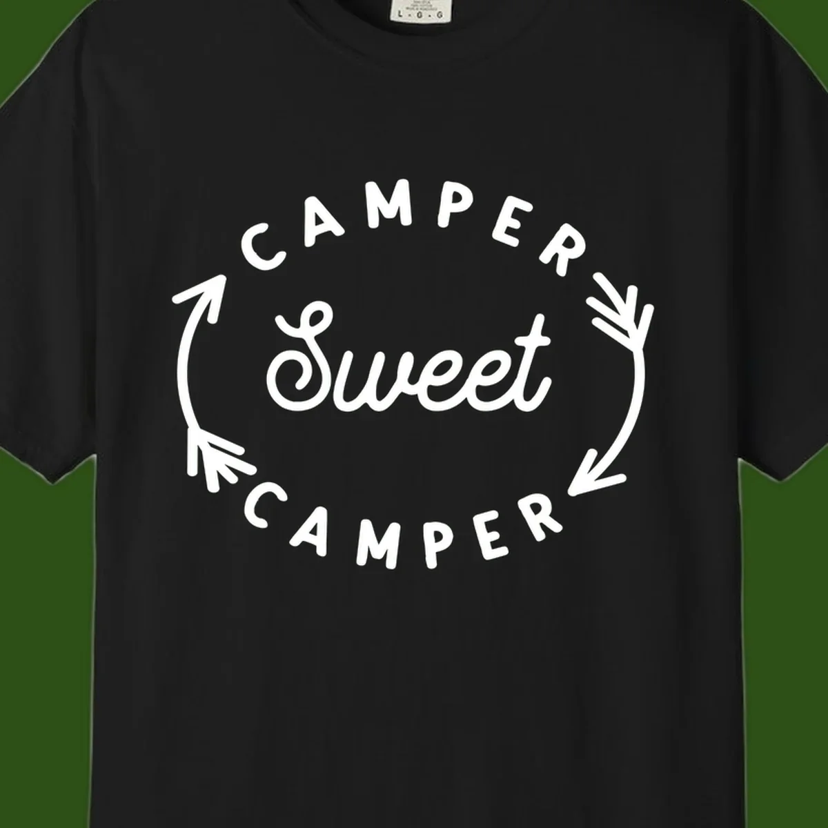 Circular badge design with 'Camper Sweet Camper' text and pine branch decorations in white on gray background