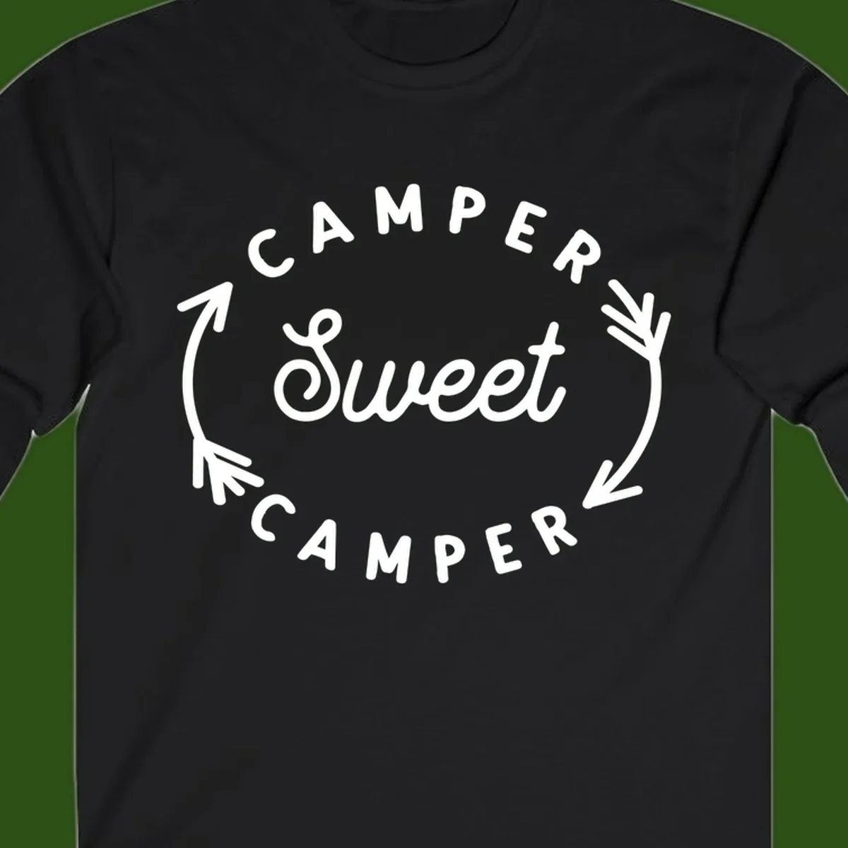 Circular badge design with 'Camper Sweet Camper' text and pine branch decorations in white on gray background