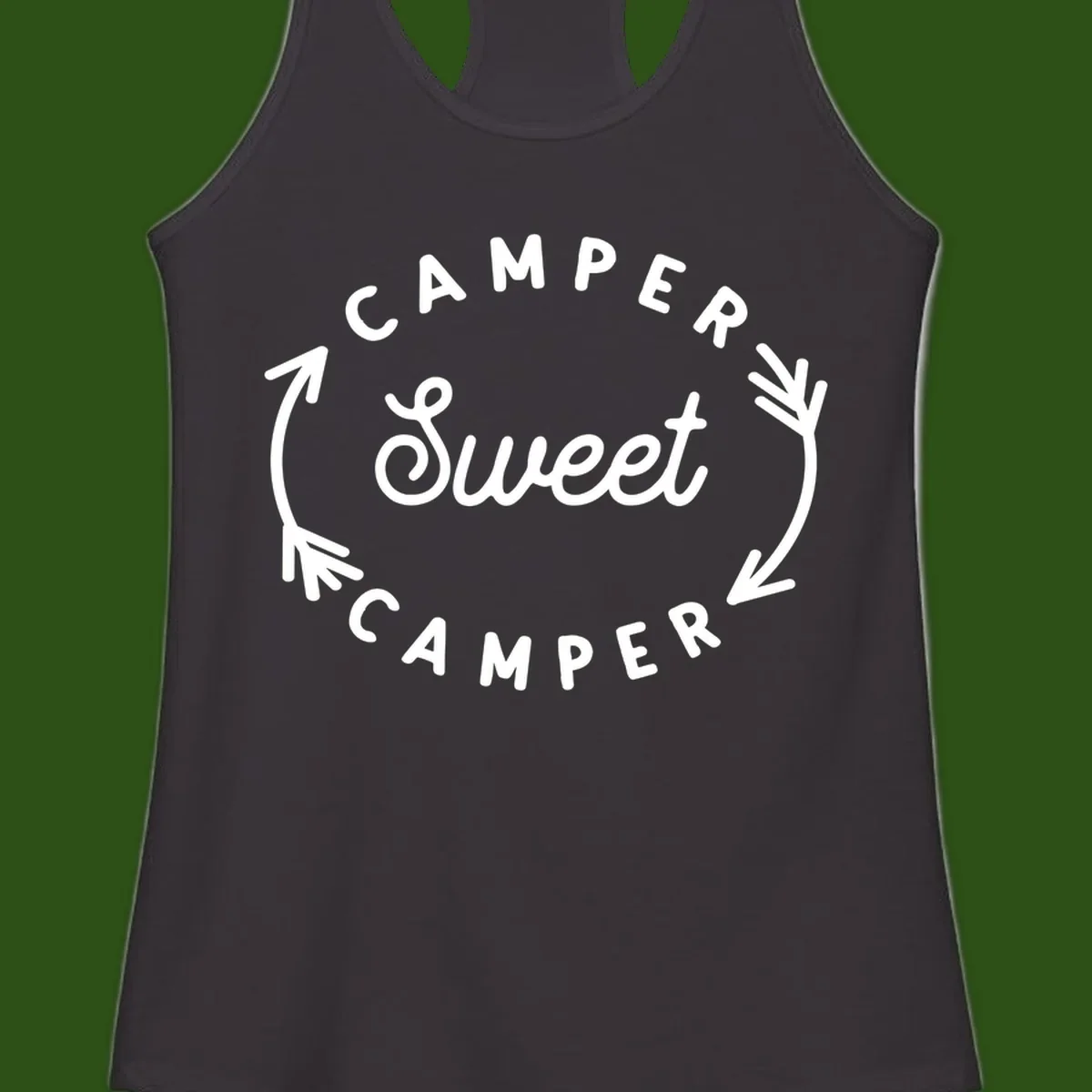 Circular badge design with 'Camper Sweet Camper' text and pine branch decorations in white on gray background