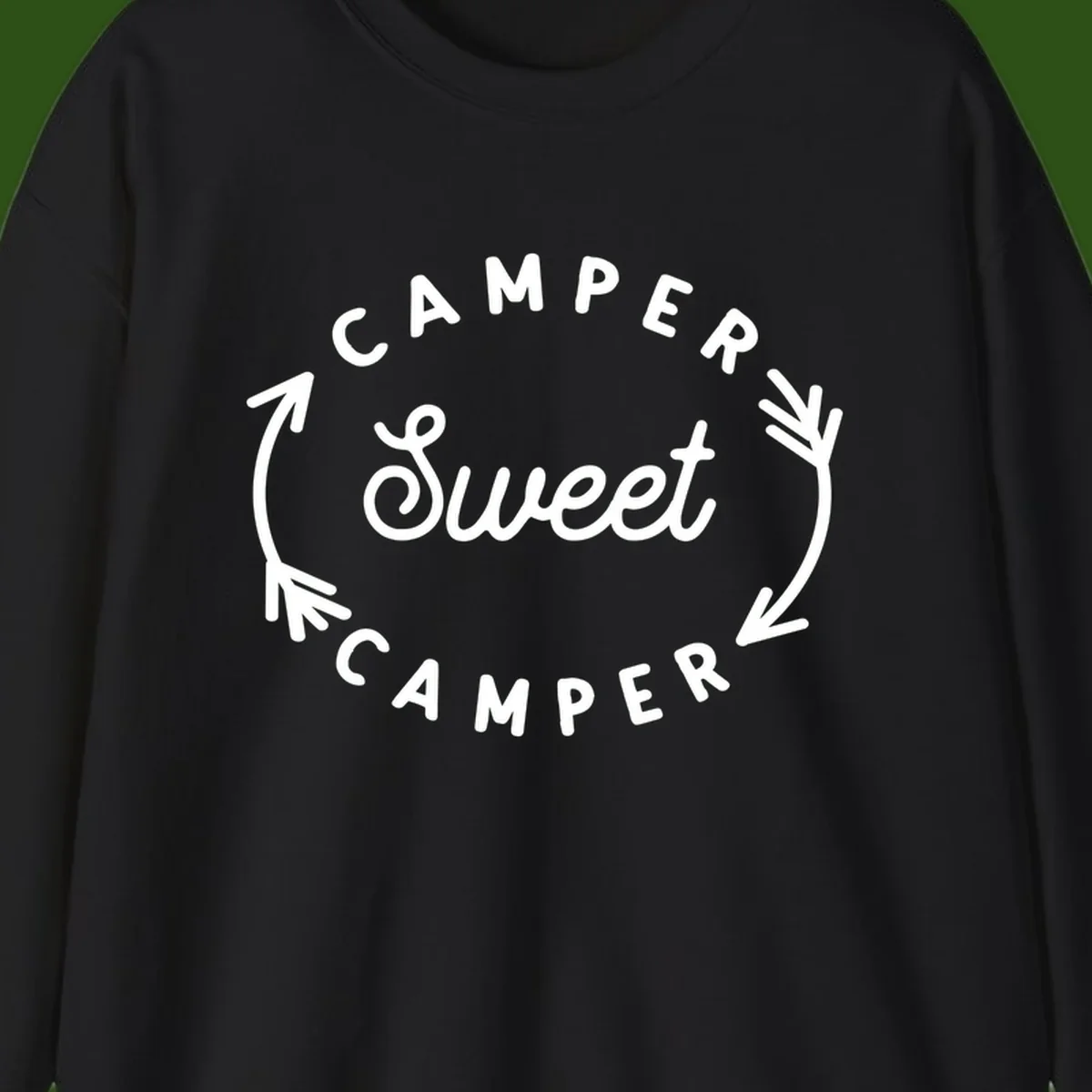 Circular badge design with 'Camper Sweet Camper' text and pine branch decorations in white on gray background