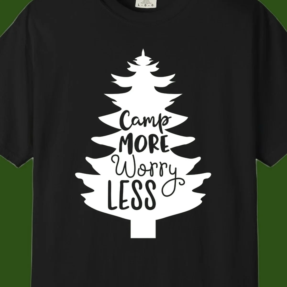 White evergreen tree silhouette with text reading 'Camp MORE Worry LESS' centered in the branches on gray background