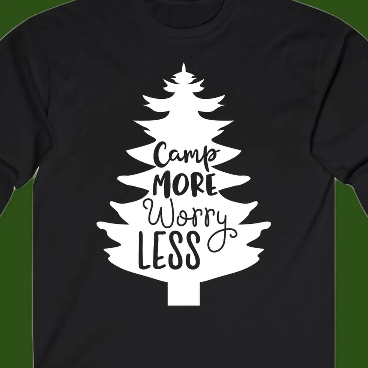 White evergreen tree silhouette with text reading 'Camp MORE Worry LESS' centered in the branches on gray background