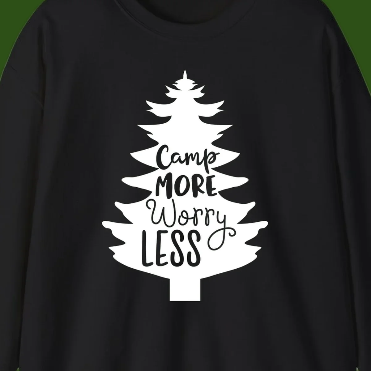 White evergreen tree silhouette with text reading 'Camp MORE Worry LESS' centered in the branches on gray background