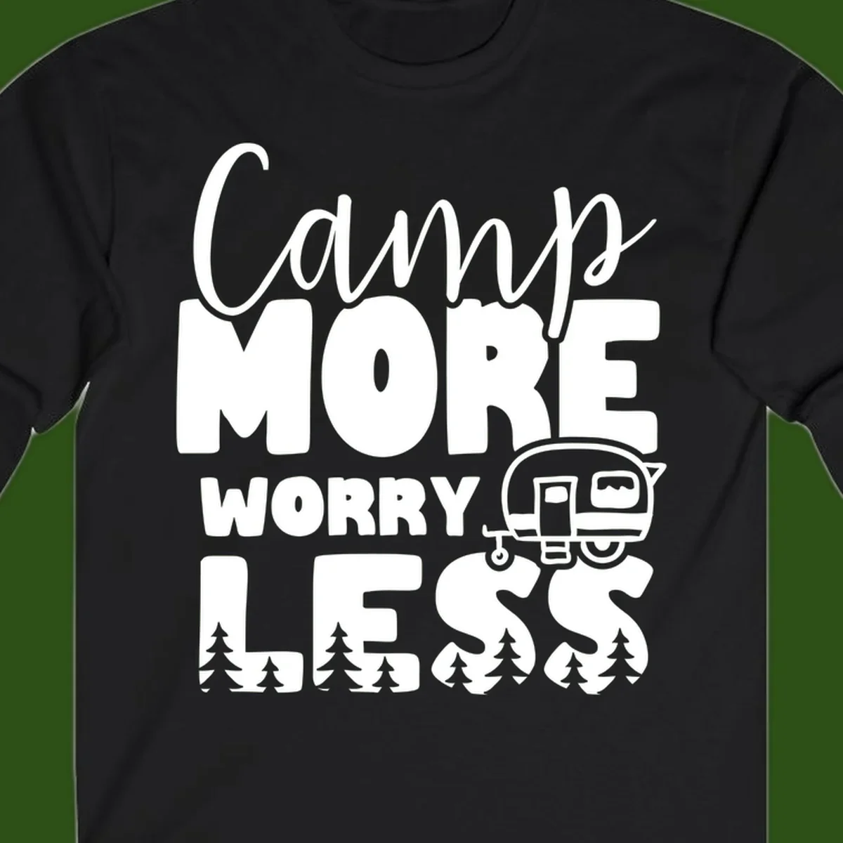Camp More Worry Less design with flowing script text, camping trailer, and pine trees on gray background