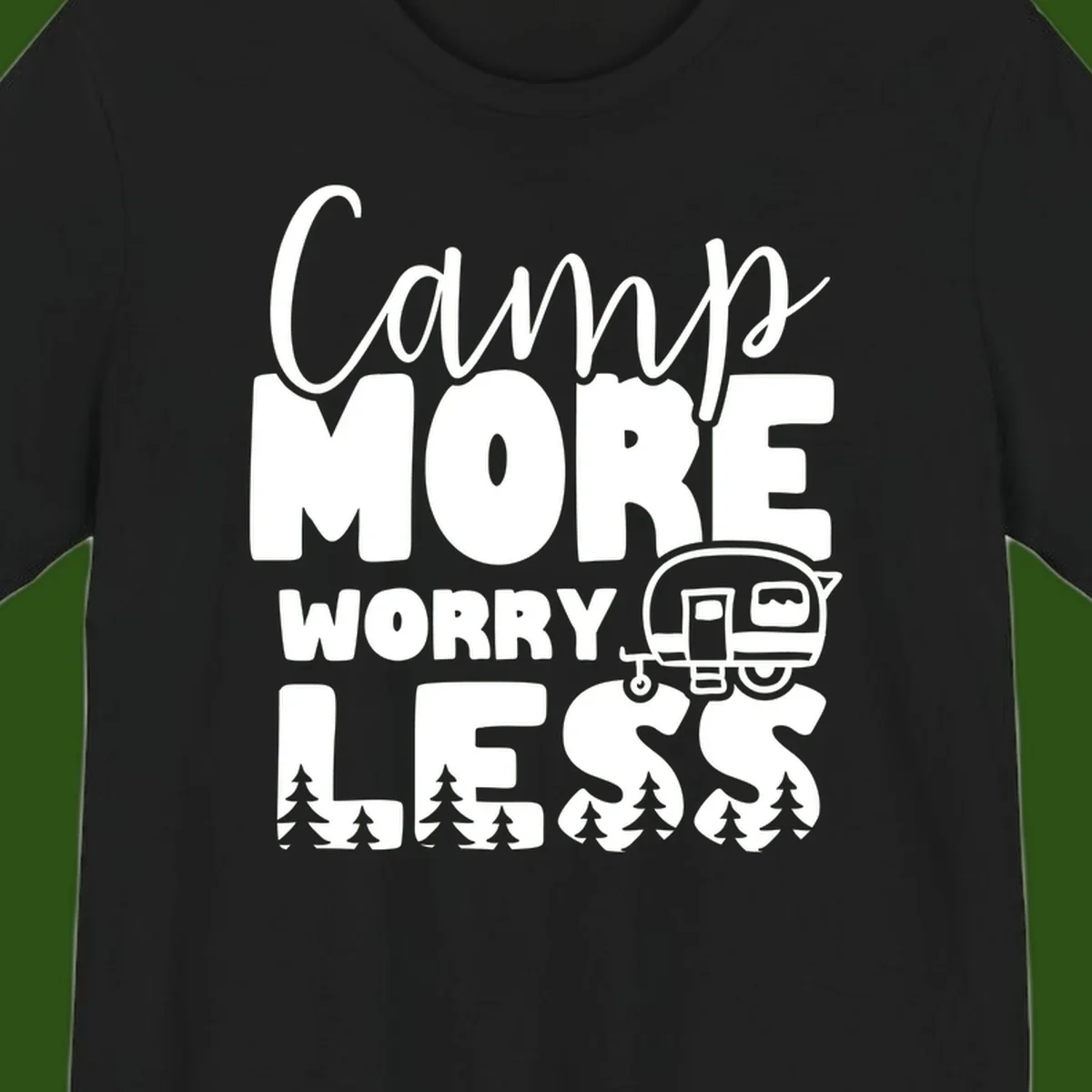 Camp More Worry Less design with flowing script text, camping trailer, and pine trees on gray background