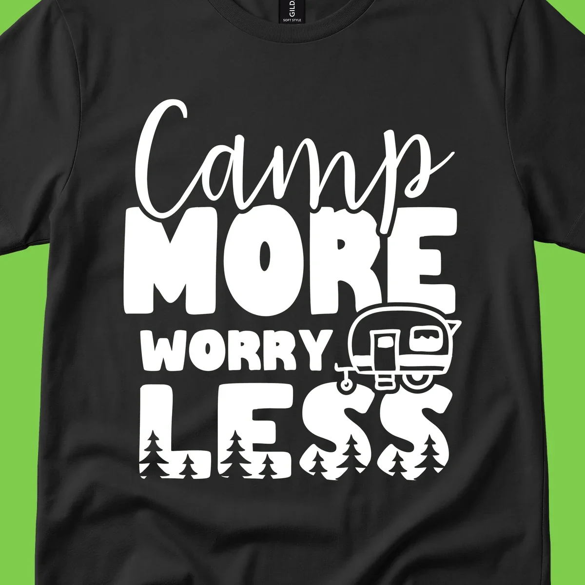 Camp More Worry Less design with flowing script text, camping trailer, and pine trees on gray background