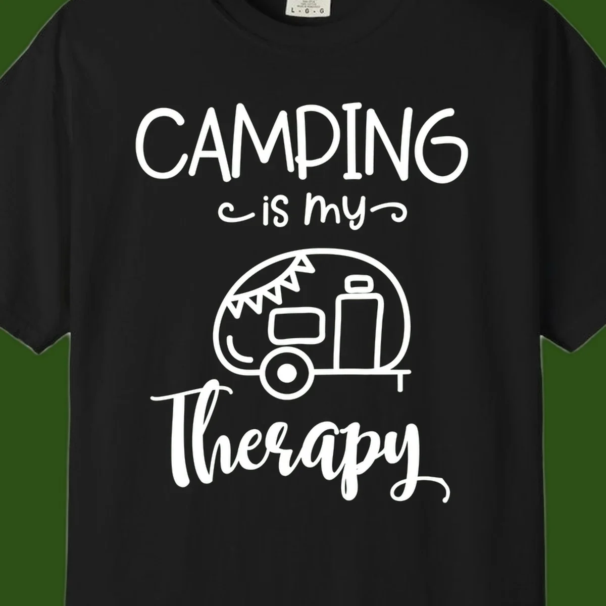 White line drawing of vintage travel trailer with bunting and text reading 'Camping is my Therapy' on gray background