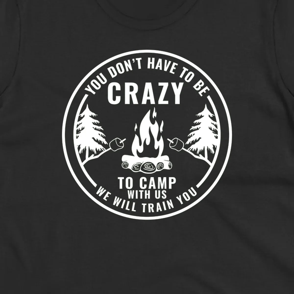 Circular badge design with campfire, pine trees, and marshmallows on sticks with humorous camping text about training crazy campers