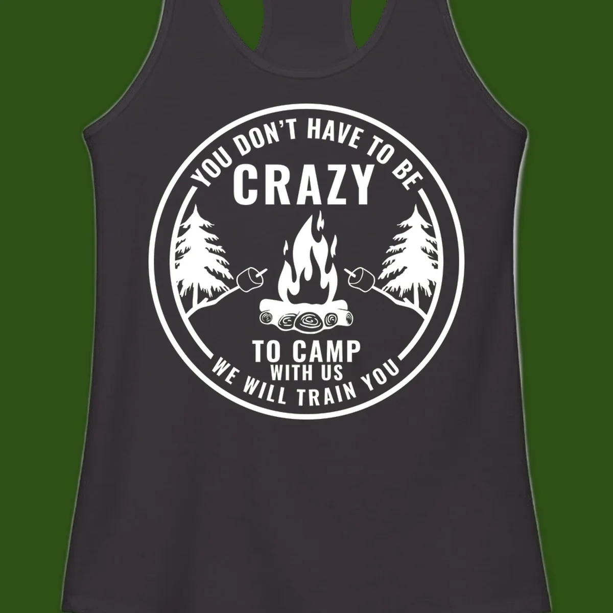 Circular badge design with campfire, pine trees, and marshmallows on sticks with humorous camping text about training crazy campers