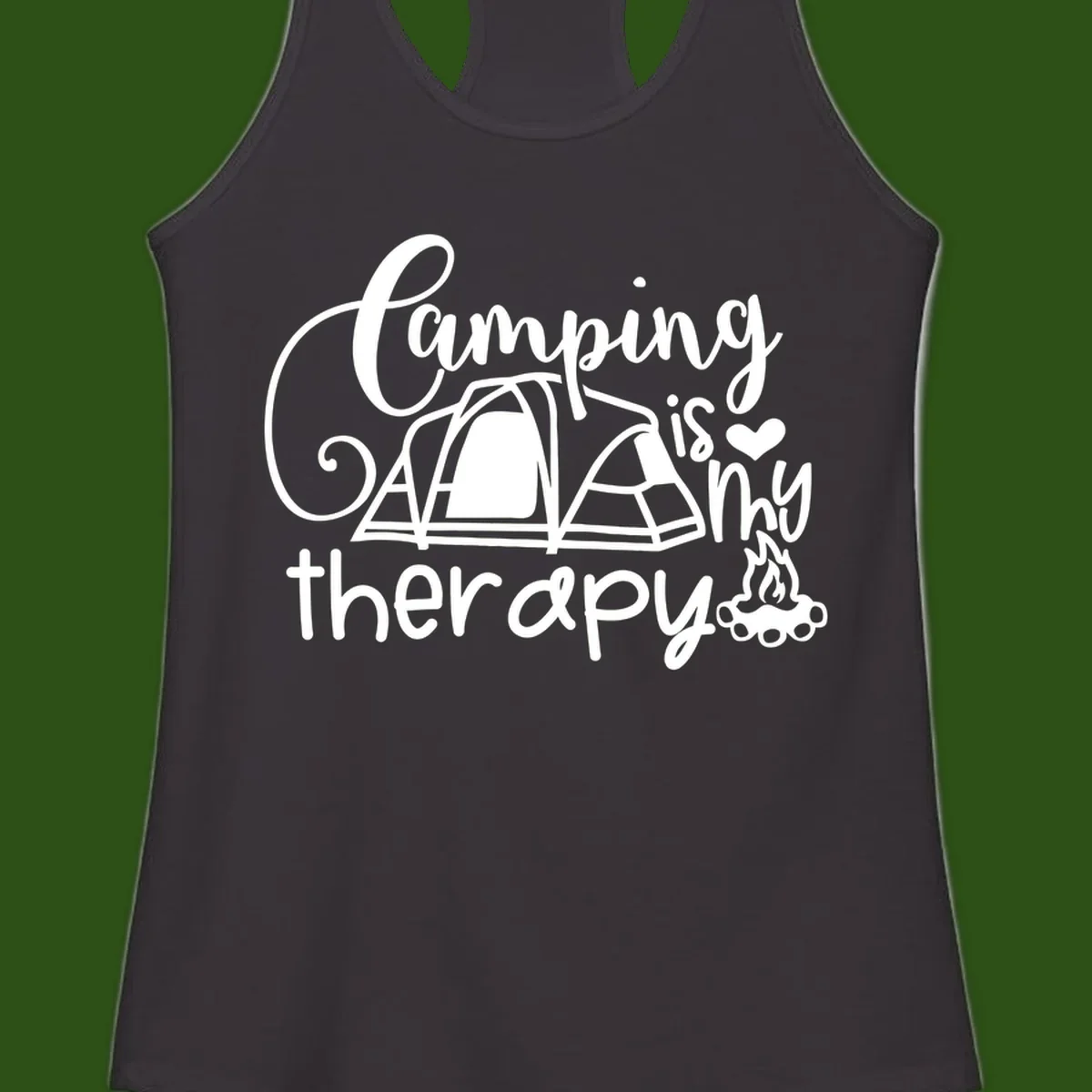 White lettered design reading 'Camping is Therapy' with heart symbol, tent, and campfire illustration on gray background