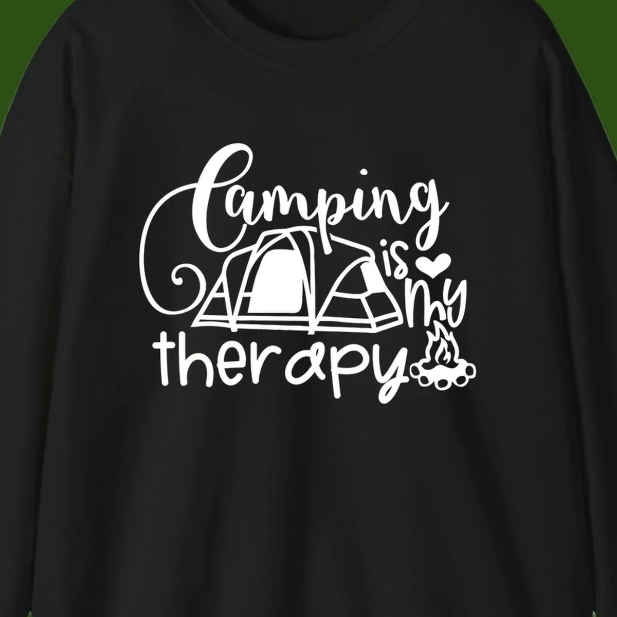 White lettered design reading 'Camping is Therapy' with heart symbol, tent, and campfire illustration on gray background