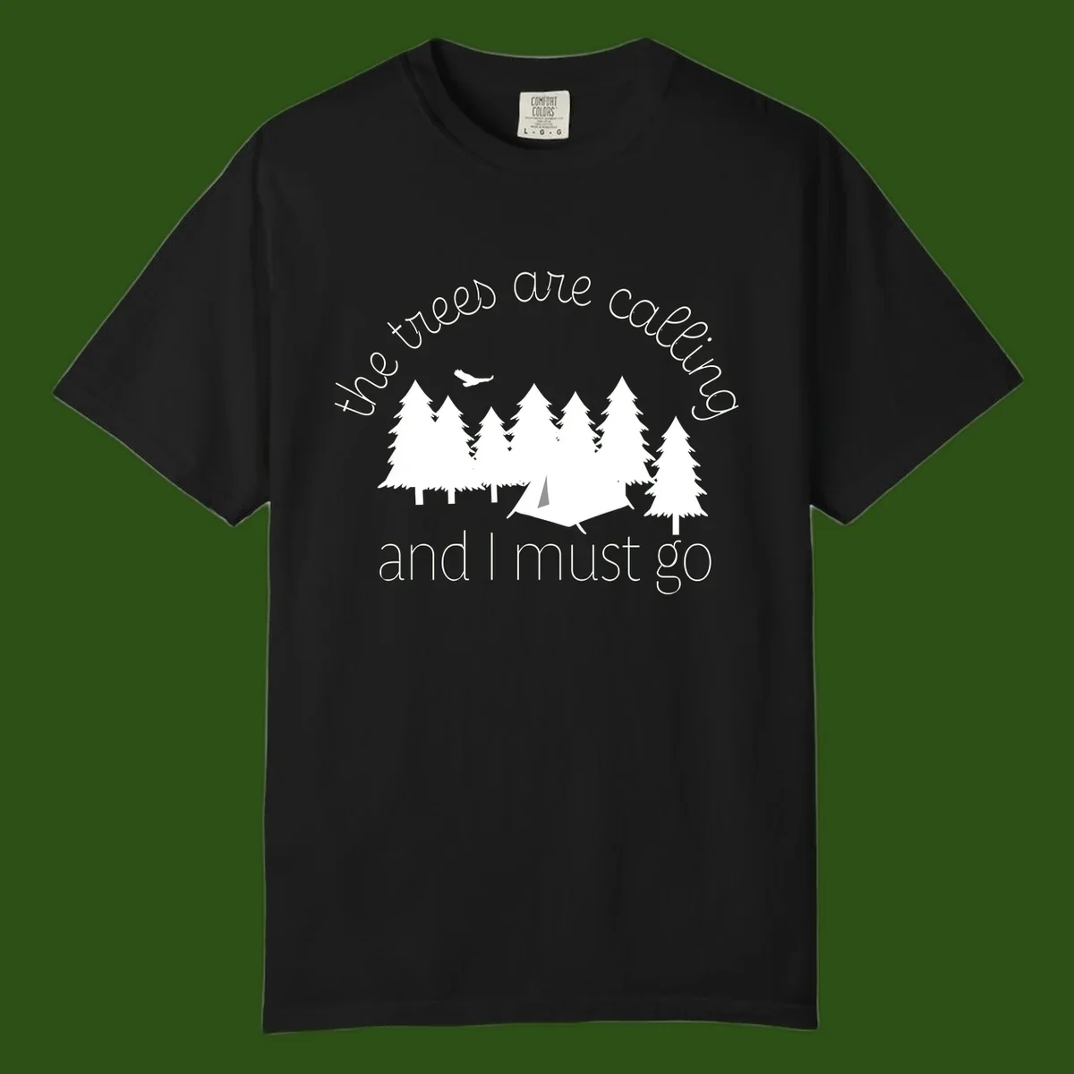 Minimalist camping design with evergreen trees, tent, and airplane with text 'The trees are calling and I must go'