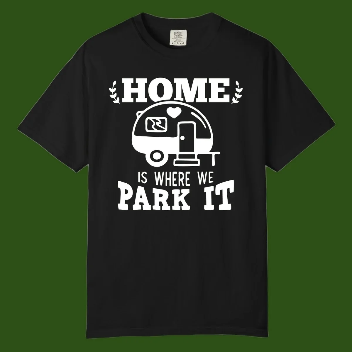 Vintage travel trailer illustration with 'Home Is Where We Park It' text and laurel wreaths on gray background
