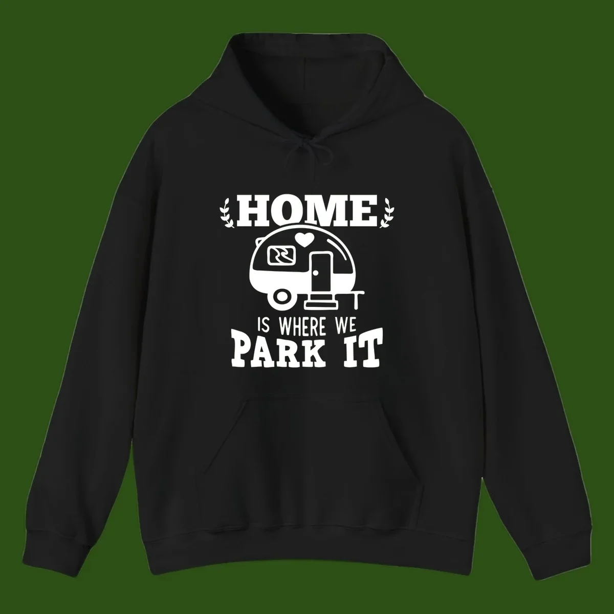 Vintage travel trailer illustration with 'Home Is Where We Park It' text and laurel wreaths on gray background