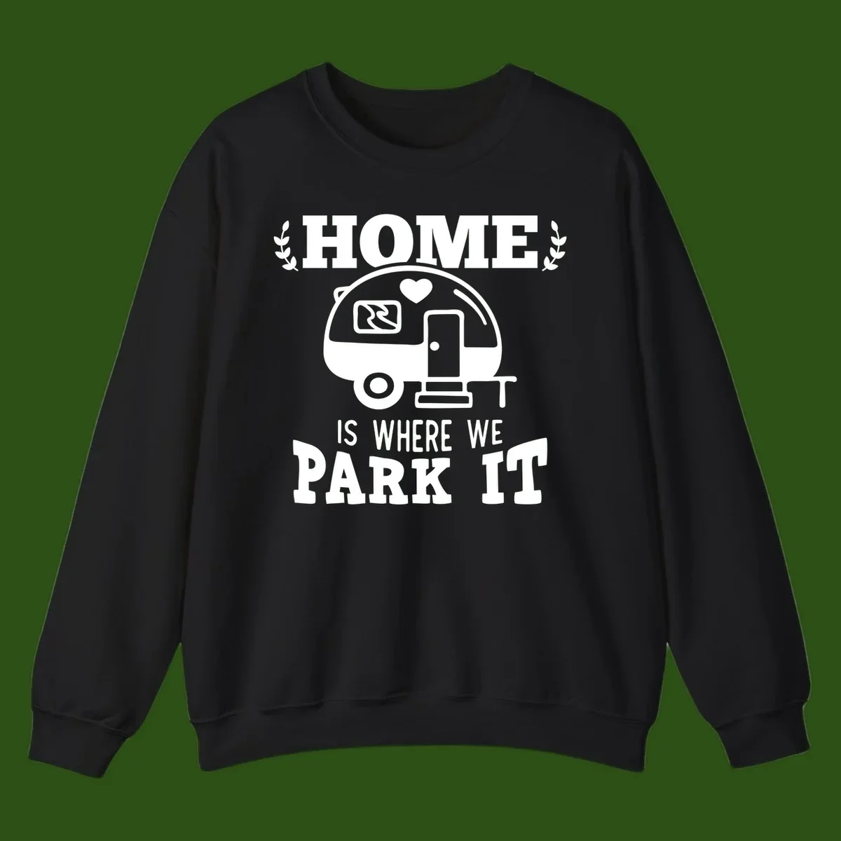 Vintage travel trailer illustration with 'Home Is Where We Park It' text and laurel wreaths on gray background