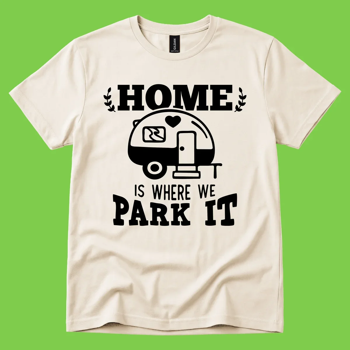 Vintage travel trailer illustration with 'Home Is Where We Park It' text and laurel wreaths on gray background