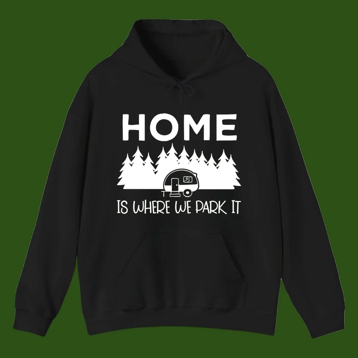 Home is where we park it design with travel trailer and forest trees on gray background