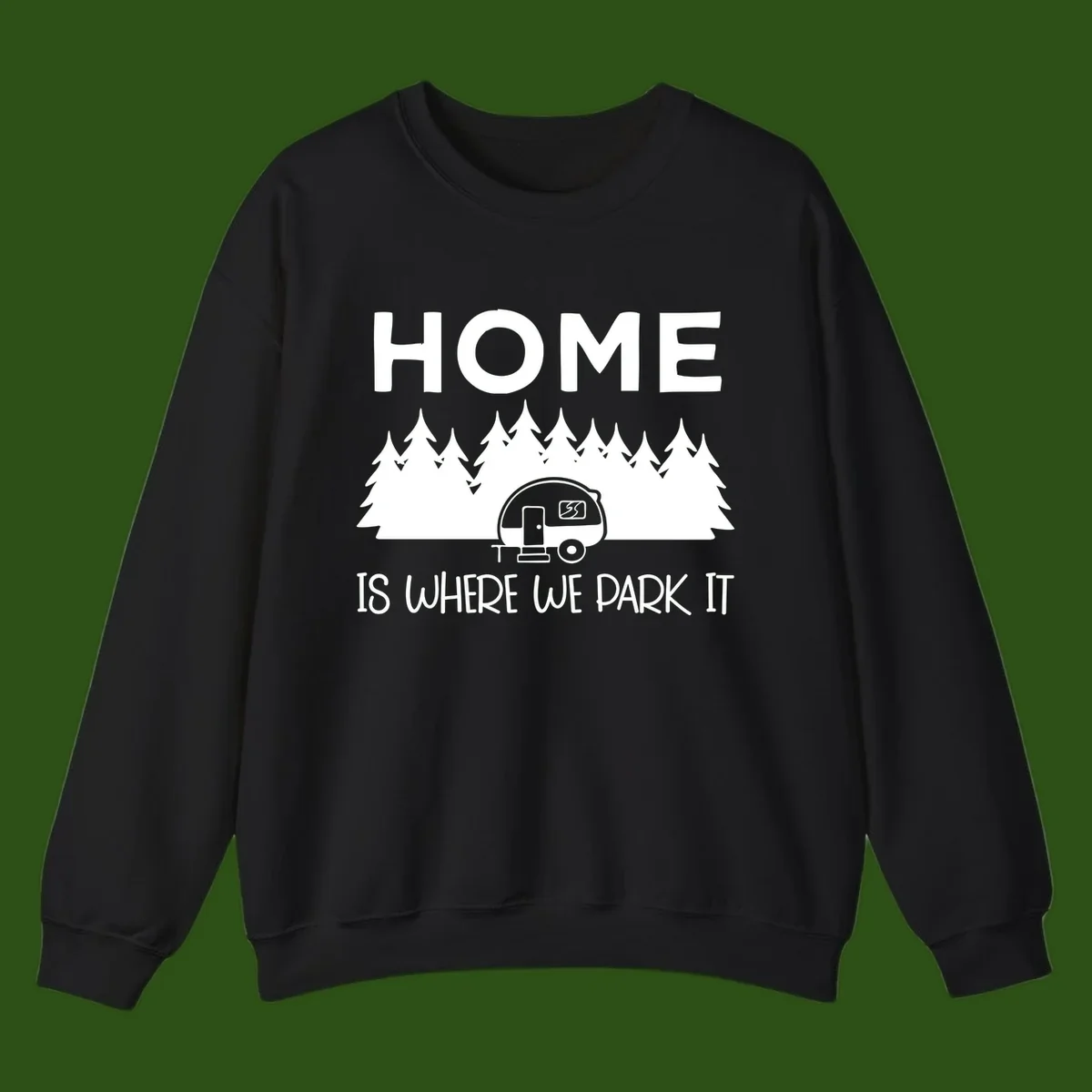 Home is where we park it design with travel trailer and forest trees on gray background