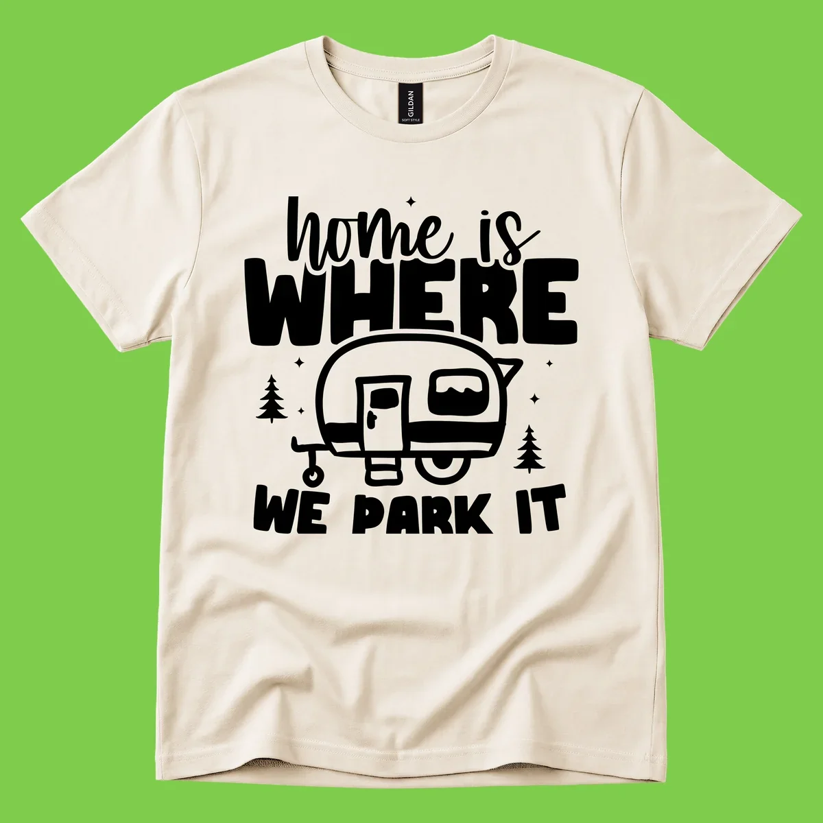 Retro-style design with 'home is where we park it' text and vintage travel trailer illustration surrounded by pine trees and sparkles