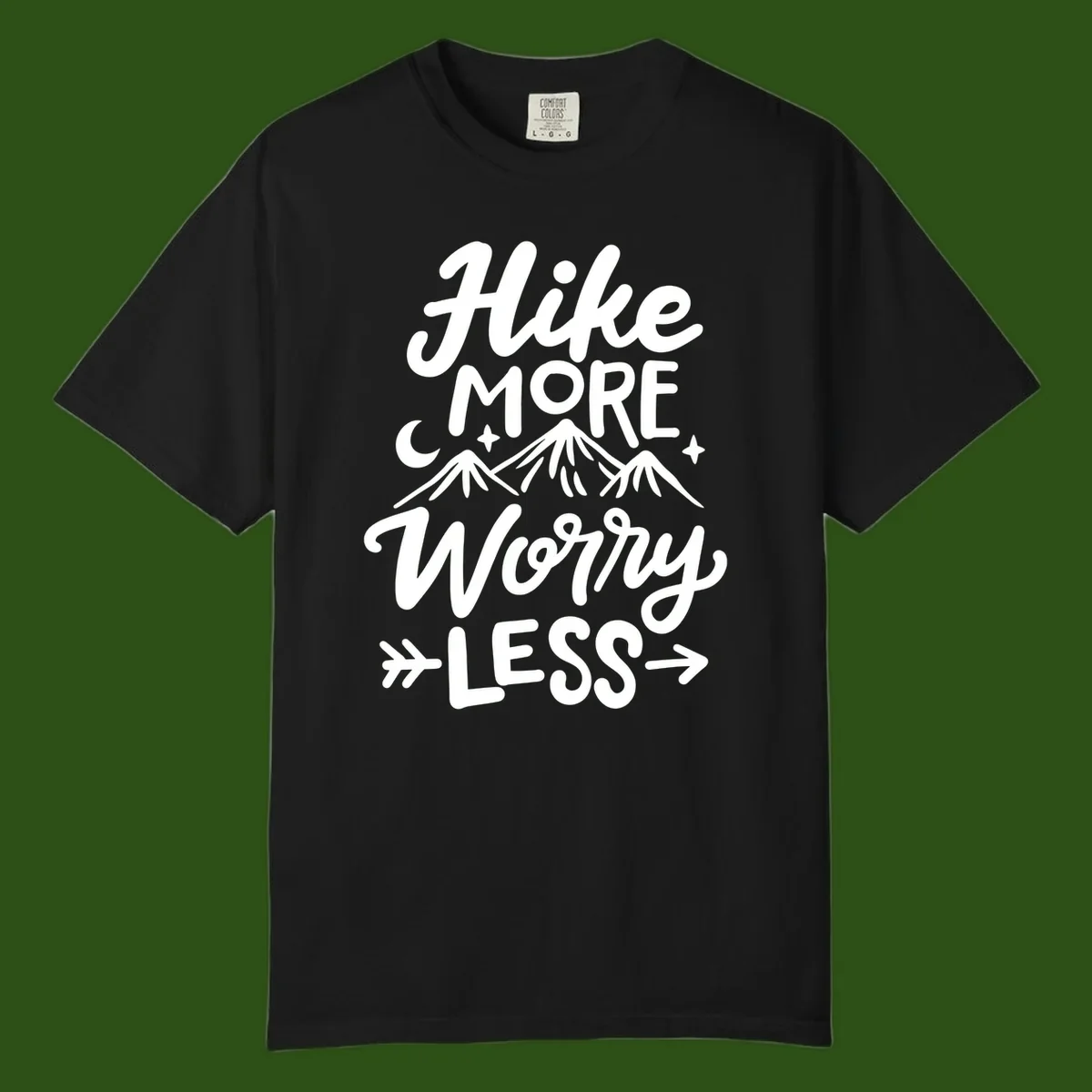 White lettered design reading 'Hike More Worry Less' with mountain peaks, moon, and stars on gray background