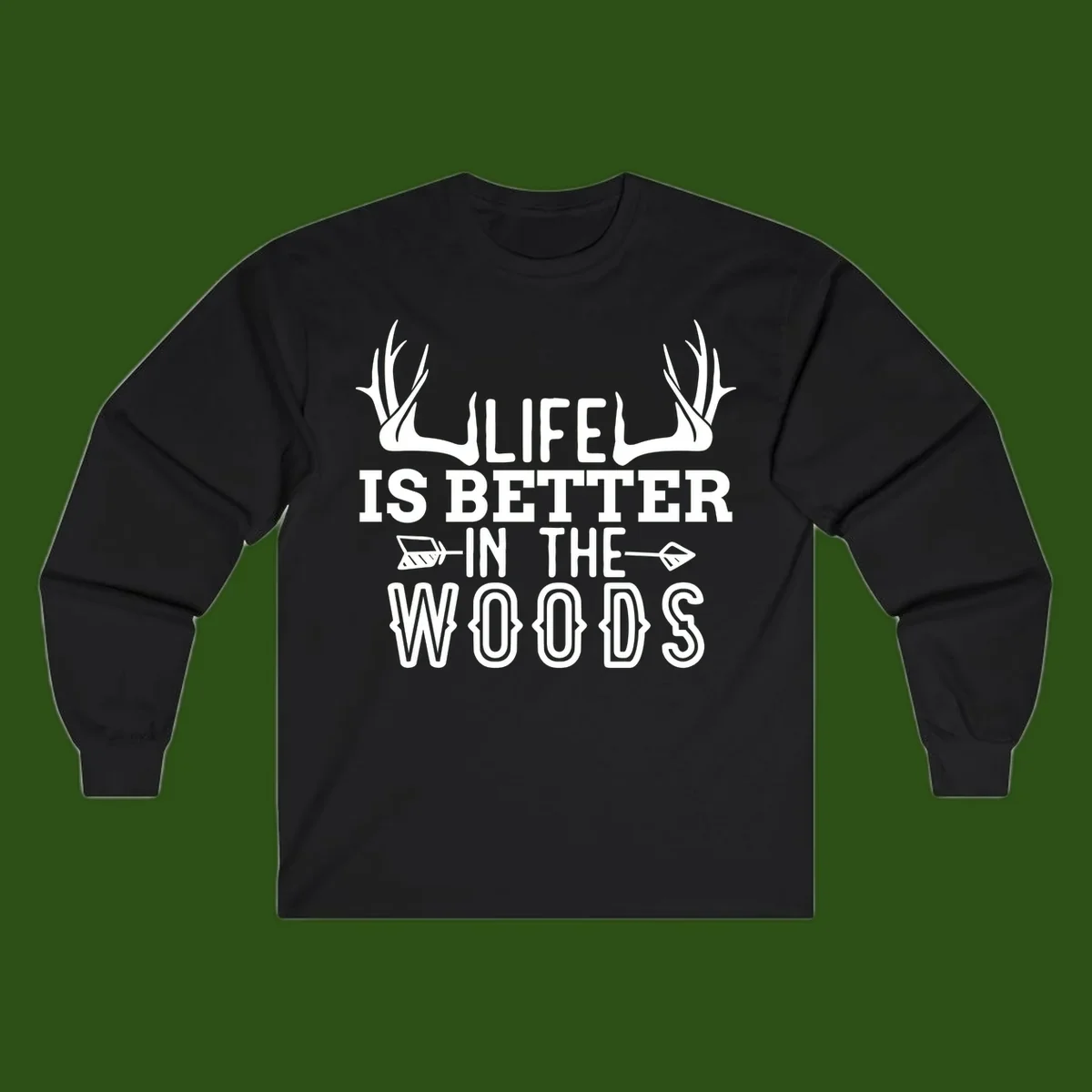 White text reading 'Life Is Better In The Woods' with deer antlers and arrows on gray background