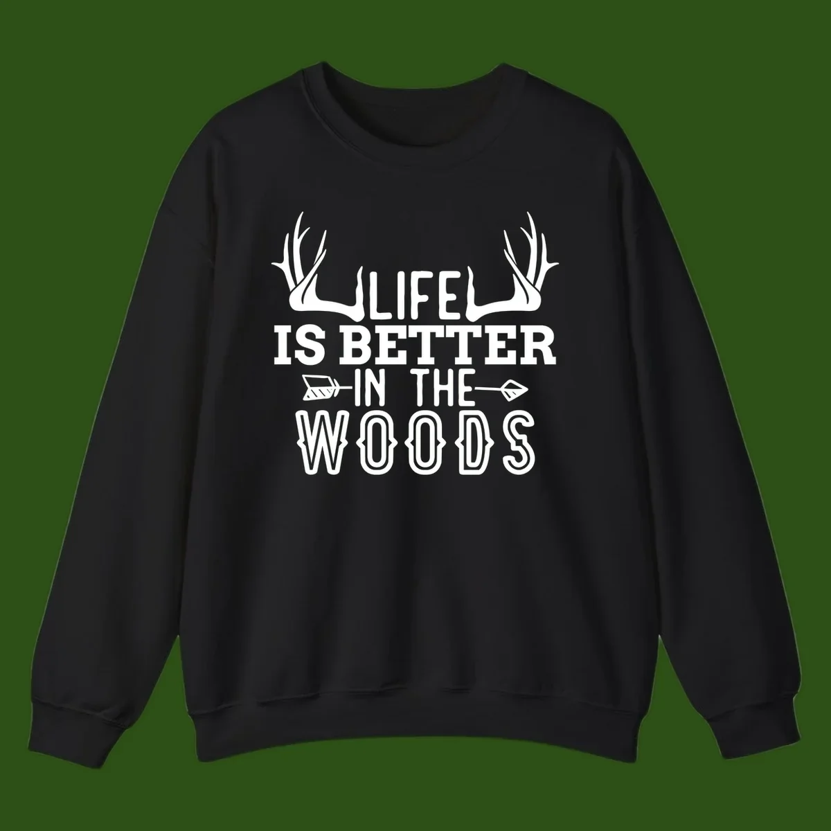 White text reading 'Life Is Better In The Woods' with deer antlers and arrows on gray background