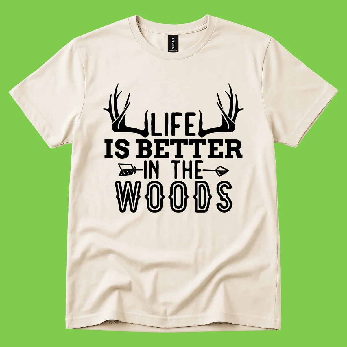 White text reading 'Life Is Better In The Woods' with deer antlers and arrows on gray background