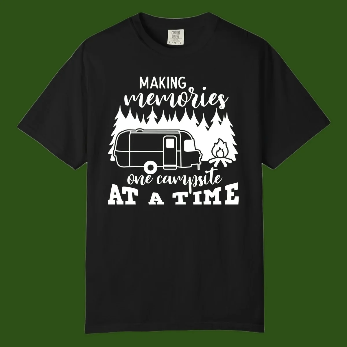 Vintage Airstream trailer parked among evergreen trees with a campfire, text reading Making Memories One Campsite At A Time