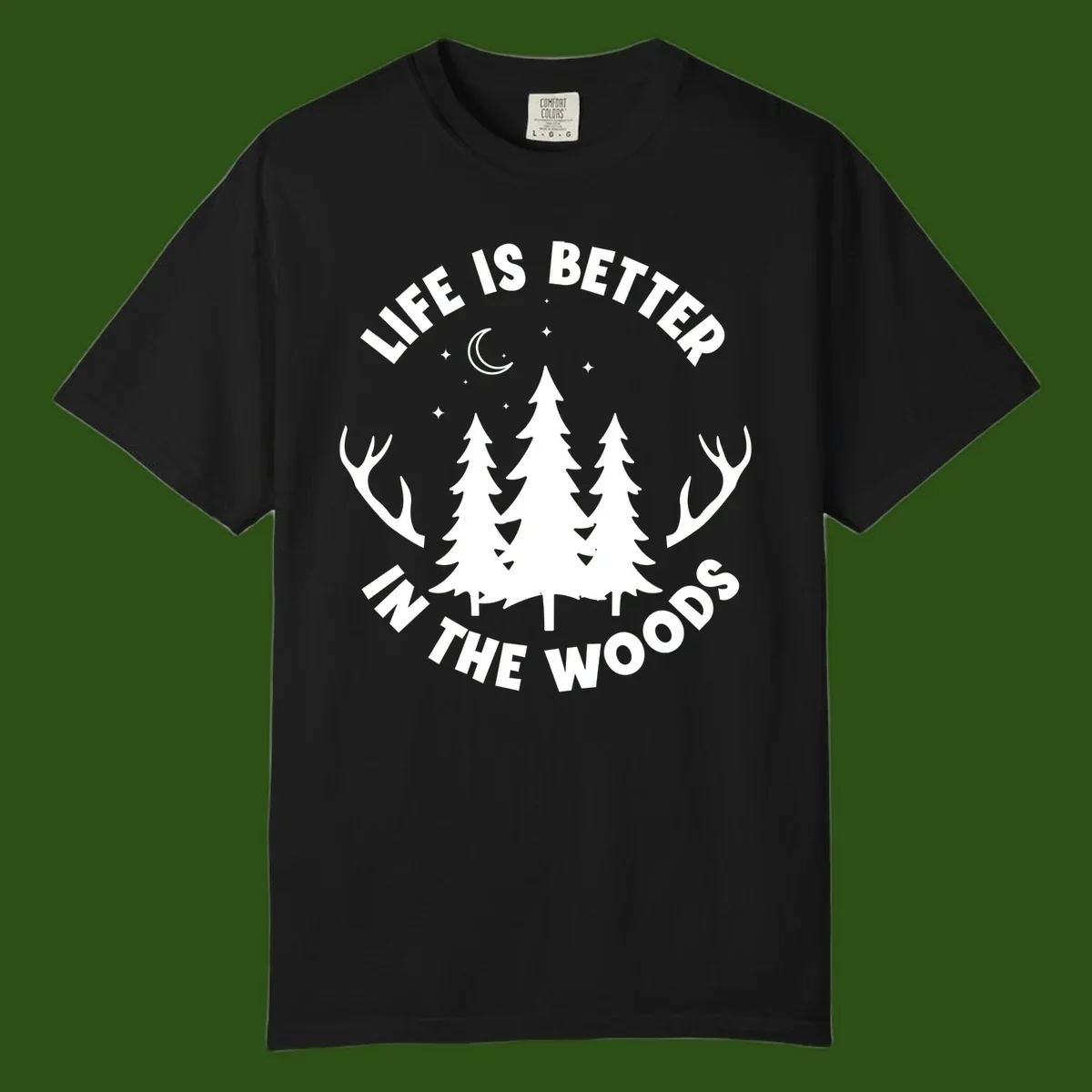 Life is better in the woods design with pine trees, deer antlers, moon and stars on gray background
