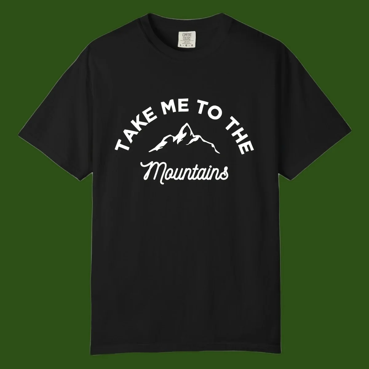 White mountain silhouette with curved text reading 'Take Me To The Mountains' on gray background