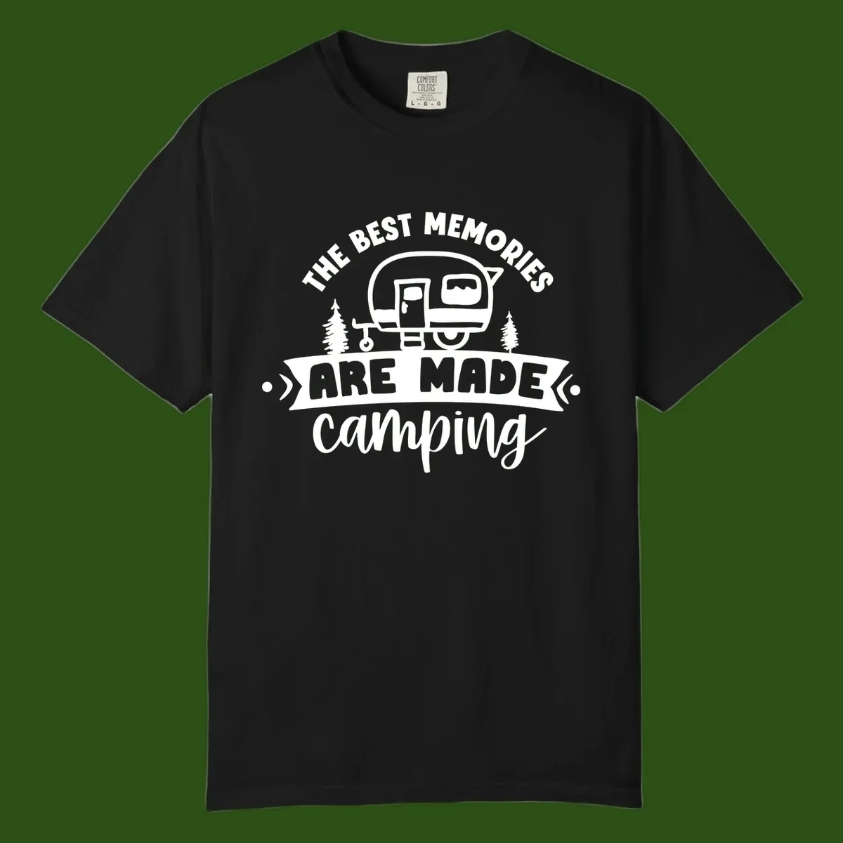 Vintage badge design with classic travel trailer, pine trees, and text reading 'The Best Memories Are Made Camping' in retro style.