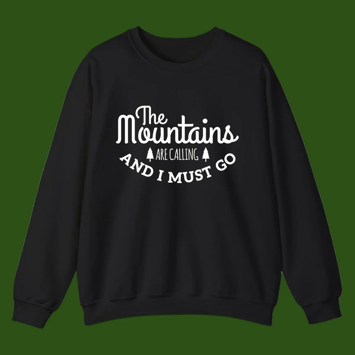 White text reading "The Mountains Are Calling And I Must Go" with pine trees on gray background