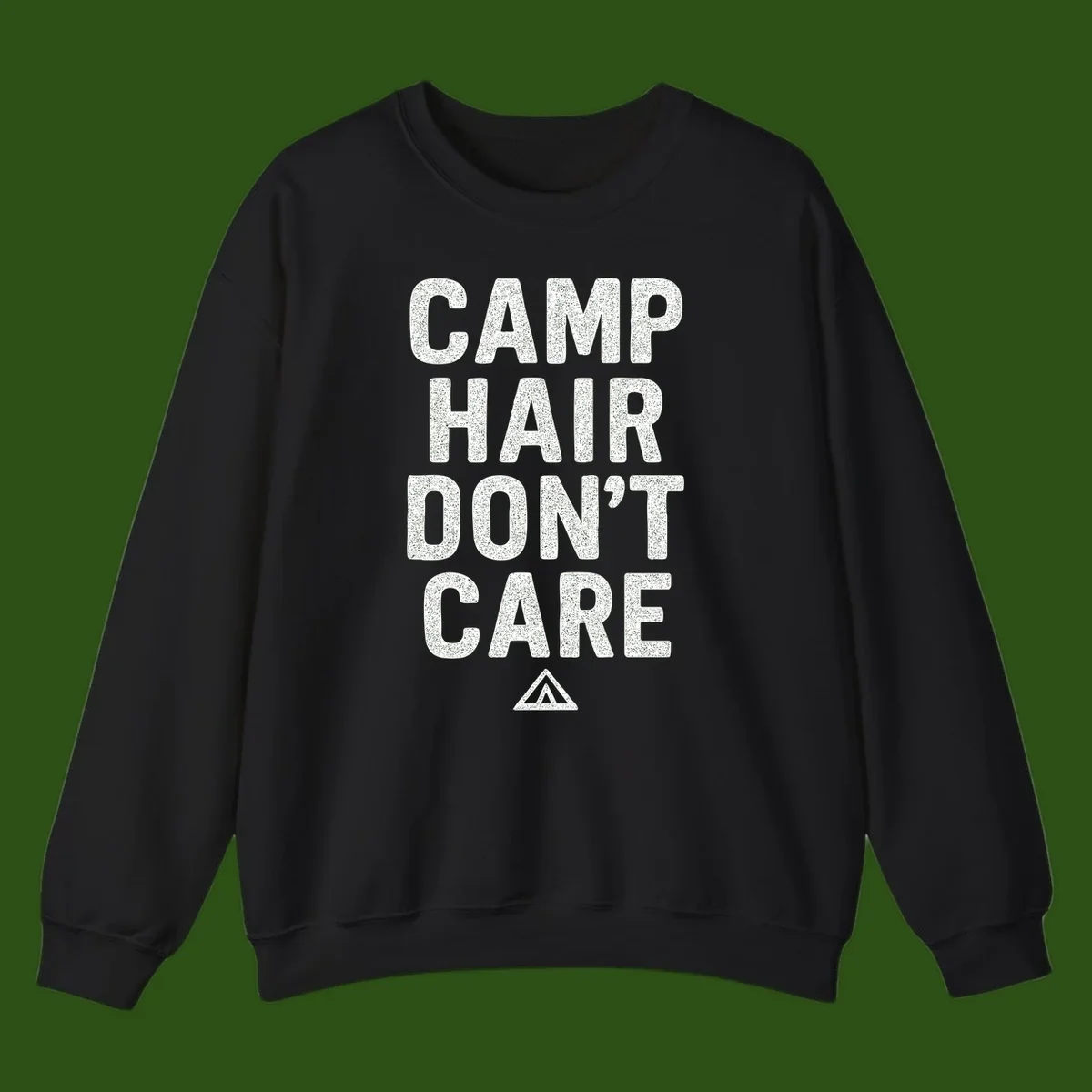 White speckled text reading 'Camp Hair Don't Care' with triangle symbol on gray background