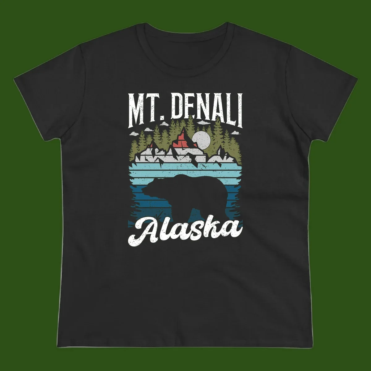Denali bear Alaska design: layered illustration with silhouetted bear emerging from water, mountain peaks, fortress, forest, and full moon.