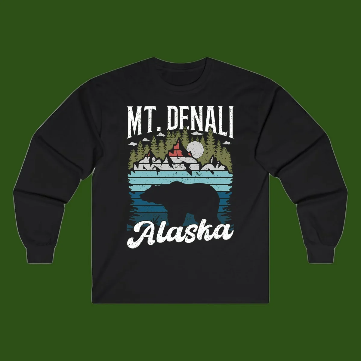 Denali bear Alaska design: layered illustration with silhouetted bear emerging from water, mountain peaks, fortress, forest, and full moon.