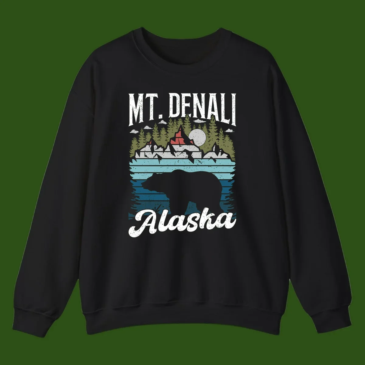 Denali bear Alaska design: layered illustration with silhouetted bear emerging from water, mountain peaks, fortress, forest, and full moon.