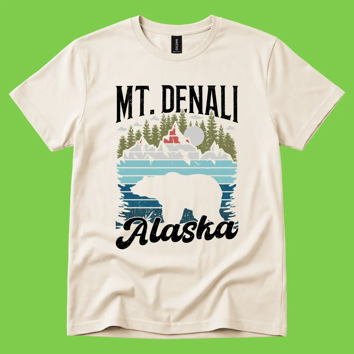 Denali bear Alaska design: layered illustration with silhouetted bear emerging from water, mountain peaks, fortress, forest, and full moon.