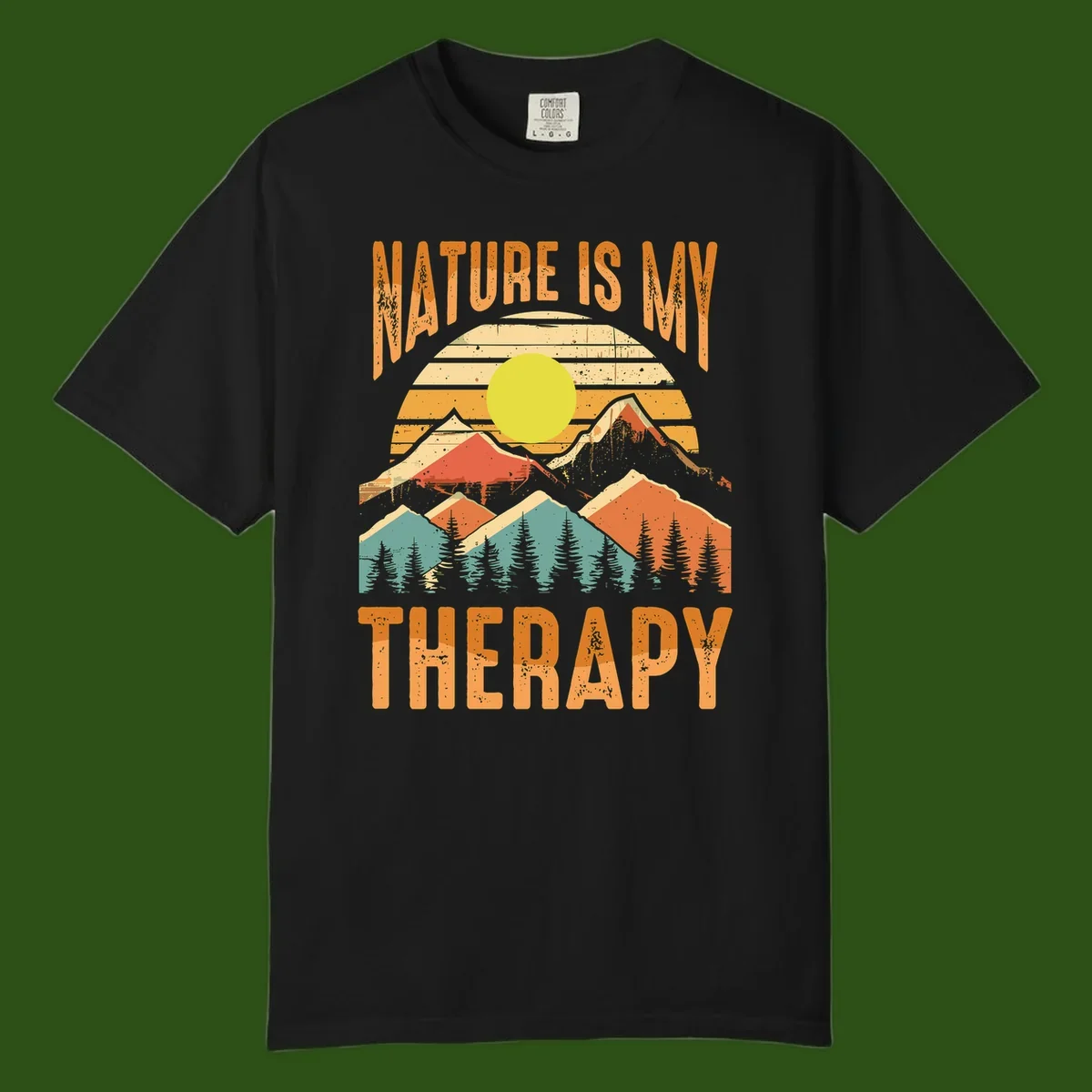Vintage-style nature is my therapy design featuring layered mountains, sun, and forest with retro stripes and distressed texture