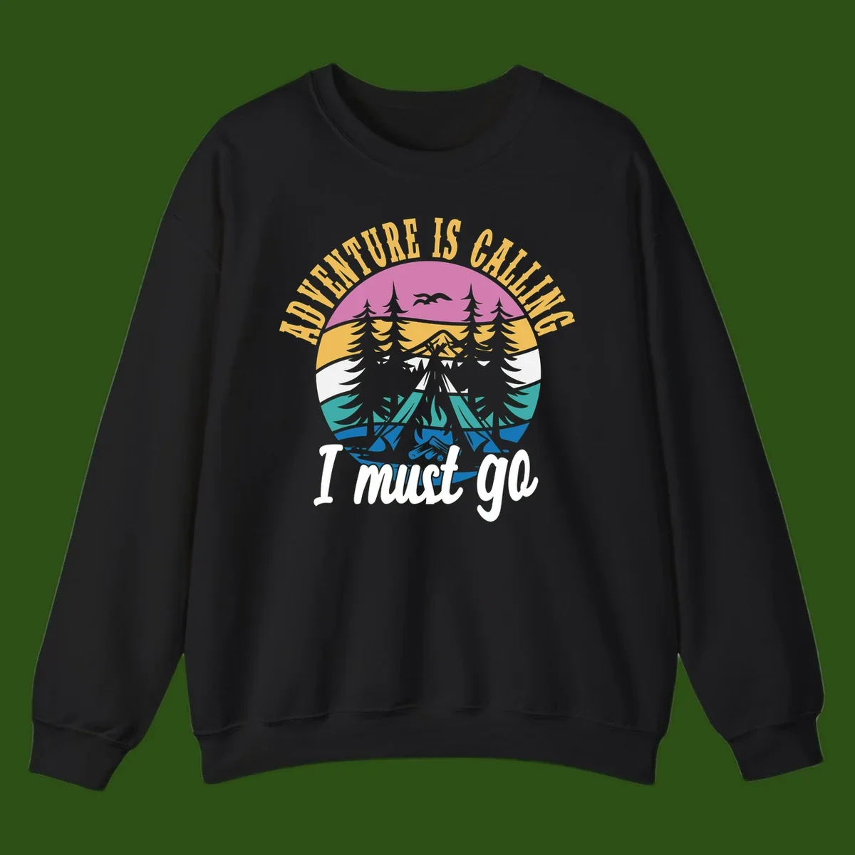 Circular badge with mountain landscape, evergreen trees, and flying birds in pink, gold, white, teal and blue with text 'Adventure Is Calling I Must Go'