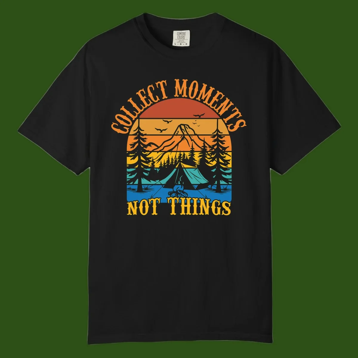 Retro layered landscape showing sunset, mountains, forest, tent and campfire with 'Quiet Mornings Not Things' text