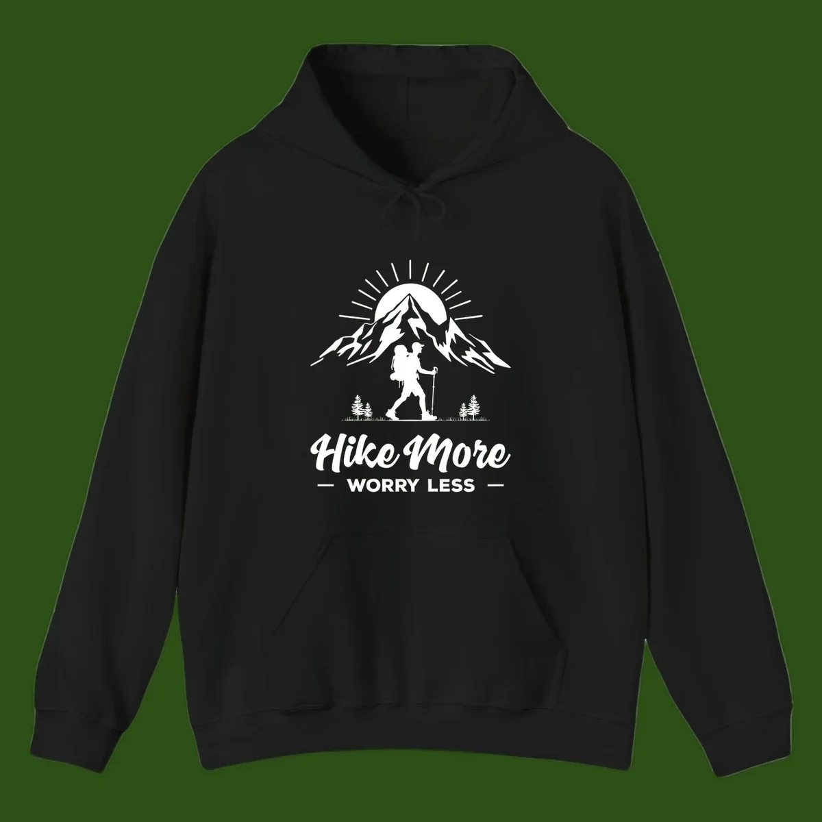 Silhouette of hiker with backpack and poles facing snow-capped mountain with radiating sun, evergreen trees below, text reads 'Hike More Worry Less'
