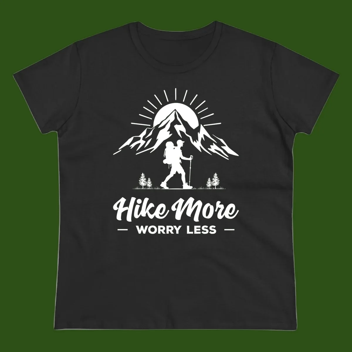 Silhouette of hiker with backpack and poles facing snow-capped mountain with radiating sun, evergreen trees below, text reads 'Hike More Worry Less'