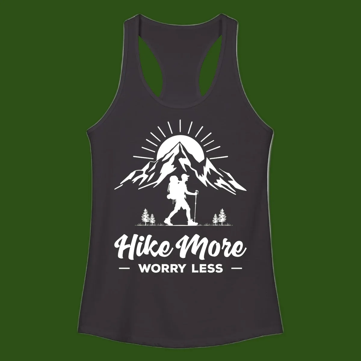 Silhouette of hiker with backpack and poles facing snow-capped mountain with radiating sun, evergreen trees below, text reads 'Hike More Worry Less'