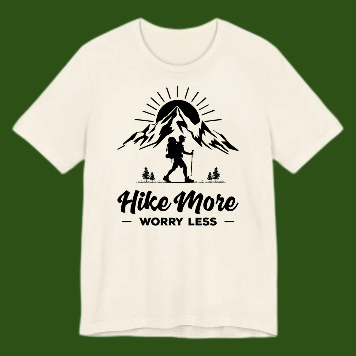 Silhouette of hiker with backpack and poles facing snow-capped mountain with radiating sun, evergreen trees below, text reads 'Hike More Worry Less'