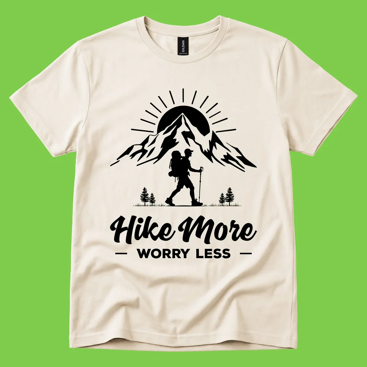 Silhouette of hiker with backpack and poles facing snow-capped mountain with radiating sun, evergreen trees below, text reads 'Hike More Worry Less'