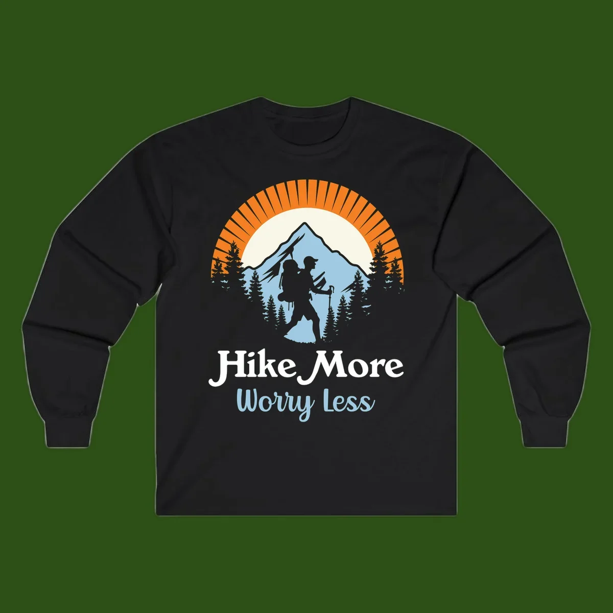 Hike more worry less badge design with silhouetted hiker, mountain peak, and evergreen forest in circular composition.