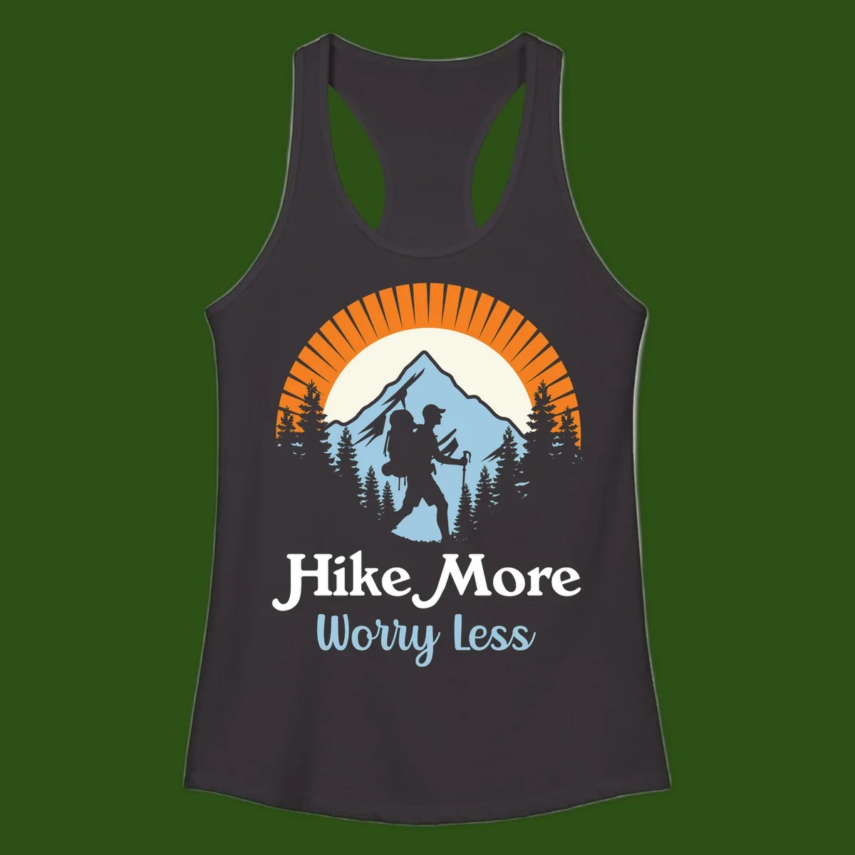 Hike more worry less badge design with silhouetted hiker, mountain peak, and evergreen forest in circular composition.